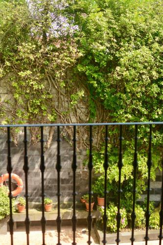 a fence with potted plants in front of a wall at Boutique Hotel Mendi Argia in Donostia-San Sebastián