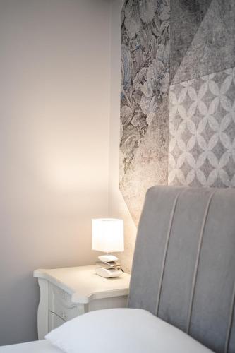 a bedroom with a bed and a table with a lamp at B&B Golden House & spa in Rose