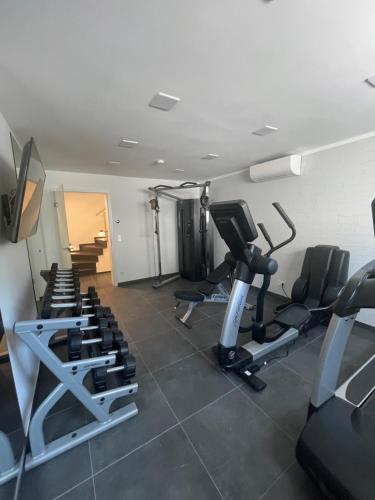 a gym with several tread machines in a room at Winkelschiffchen III mit Sauna in Juist