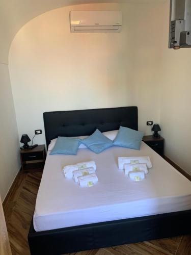 a bed in a room with two pillows on it at Casa Balilla in La Maddalena