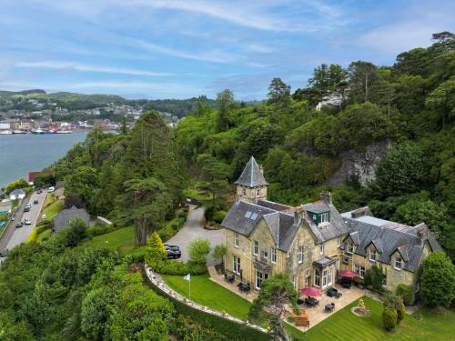 an aerial view of a house on a hill next to the water at Dungallan Country House Bed & Breakfast in Oban