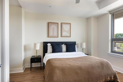 a bedroom with a large bed with blue pillows at Pentagon City 1br w pool gym nr downtown WDC-696 in Arlington