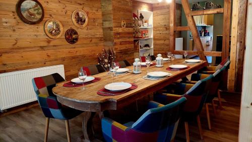 a large wooden table in a room with chairs at De nussi's chalet 3 in Bach