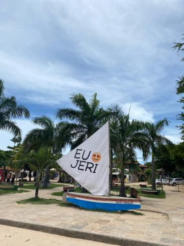 a sign in a park with palm trees at Pousada Maria do Lampião Jericoacoara- Antigo Jeri Vila Mini in Jericoacoara