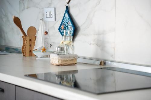 a kitchen counter with a glass table with a toy boat on it at La Casa di Sossy in Civitanova Marche