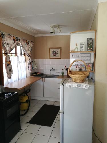 a kitchen with a white refrigerator and a sink at Snow Cottage in Rhodes