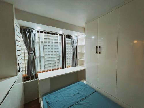 a small room with a window and a blue floor at Cua Bac Modern Home in Central Hanoi in Hanoi