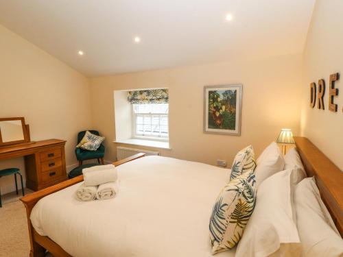 a bedroom with a large bed and a desk at 4 Martindales Yard in Kendal