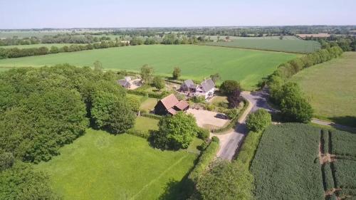 an aerial view of a house in a field at Corner Farm Barn in Halesworth