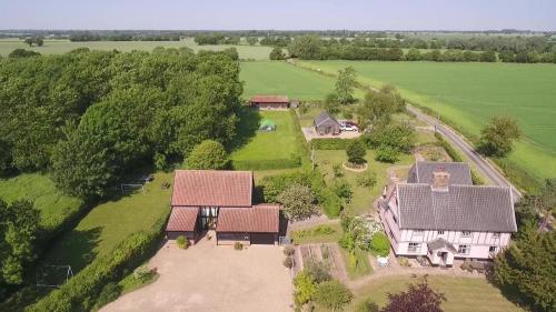 an aerial view of a house with a yard at Corner Farm Barn in Halesworth