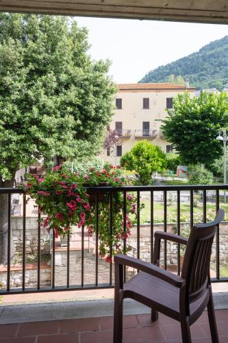 a bench sitting on a balcony looking out at a building at Hotel San Marco in Gubbio