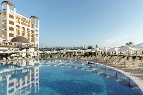a large swimming pool in front of a hotel at Alua Helios Bay - All Inclusive in Obzor