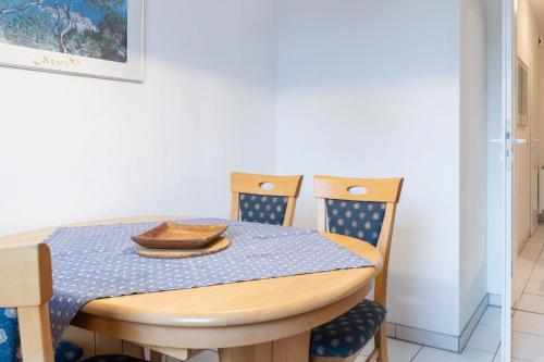 uma mesa de jantar e cadeiras com uma toalha de mesa azul em Haus Roland Wohnung 03 em Zinnowitz