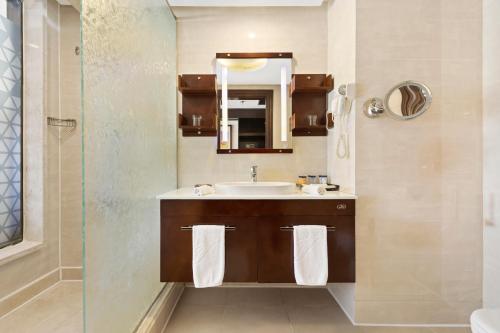 a bathroom with a sink and a mirror at Pickalbatros White Beach Resort - Hurghada in Hurghada