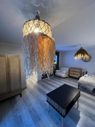 a living room with a large chandelier and a table at Na Spokojnie in Jastarnia