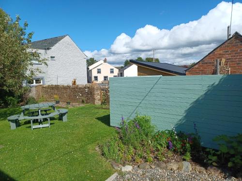 a picnic table in the yard of a backyard at Green View Lodges in Wigton