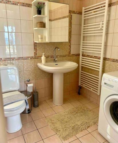 a bathroom with a sink and a toilet at Sea View Apartment #2 in Stalos