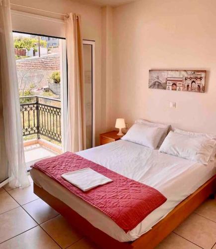 a bedroom with a large bed and a window at Sea View Apartment #2 in Stalos