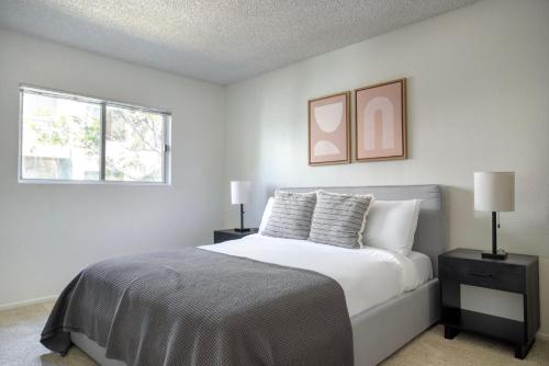 a white bedroom with a bed and two windows at Playa Vista 2br w gym pool nr beach LAX LAX-1085 in Los Angeles