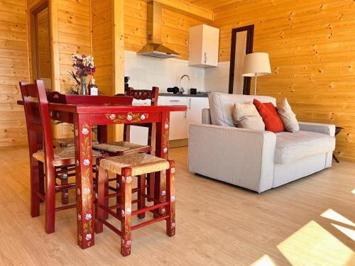 a kitchen and living room with a table and a couch at Monte dos Cordeiros in Vila Viçosa