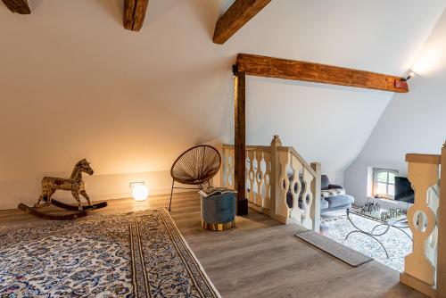 Una habitación con una escalera con un caballo mecedor y una alfombra en Nannings Huis en Oevenum