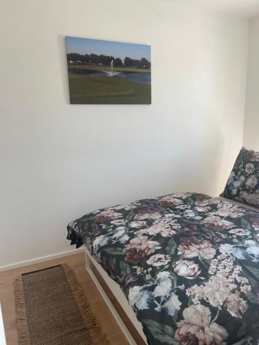 a bedroom with a bed and a picture on the wall at Aparthotel Green Resort in Hrubá Borša