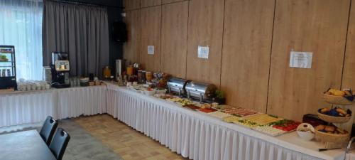 a buffet line with food on it in a room at Ośrodek Promenada- Horyzont in Jastrzębia Góra