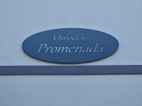 a blue sign with the name of a company at Ośrodek Promenada- Faleza in Jastrzębia Góra