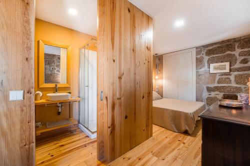 a small bedroom with a bed and a bathroom at Stone-crafted tranquility with a relaxing pool in Taide