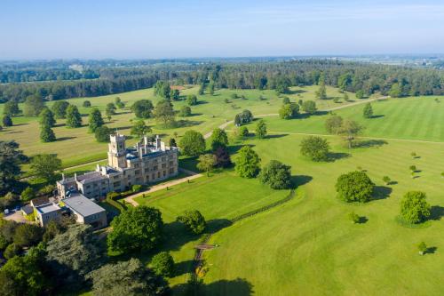 an aerial view of a mansion in a field at The Garden Suite at Shuttleworth in Old Warden