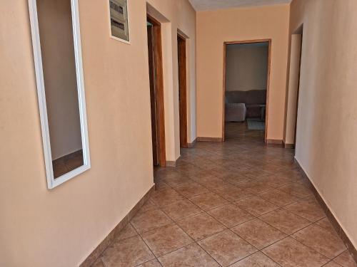 a hallway with a tile floor in a house at Mara in Zadar