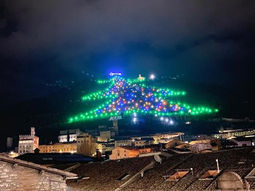 a group of green lights on a mountain at night at L’ OTTAVA MERAVIGLIA in Gubbio