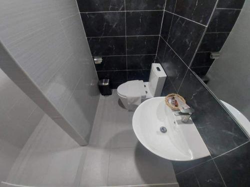 a bathroom with a sink and a toilet at Na Sukhothai Hotel in Sukhothai