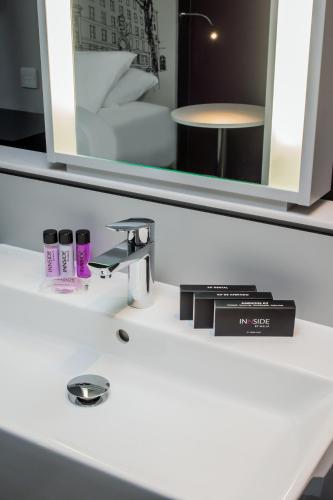 a bathroom counter with a sink and a mirror at INNSiDE by Meliá Manchester in Manchester