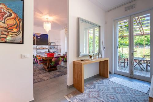 a living room with a table and a dining room at Exclusive Duplex Villa con piscina e vista in Strognano
