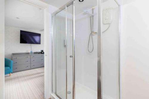 a shower with a glass door in a bathroom at Room 6, Hotel style Double bedroom in Marazion in Marazion