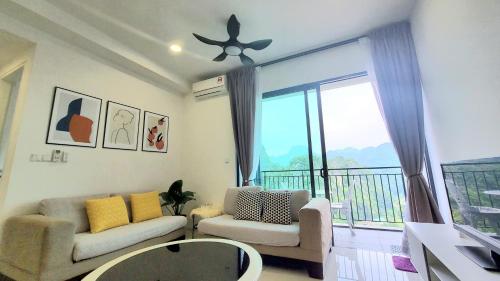 a living room with a couch and a balcony at Lost World Of Tambun Coco Guest House in Ipoh