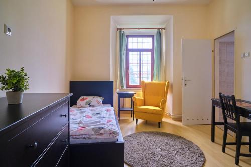 a bedroom with a bed and a desk and a chair at Samostan Mekinje in Kamnik