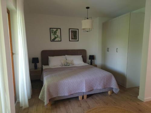 a bedroom with a large bed and two lamps at Mystica - charming studio apartment on the beach in Kruševo