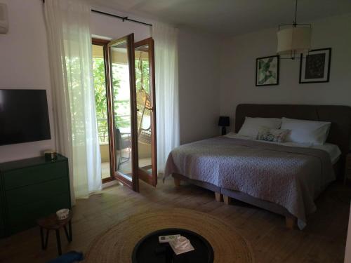 a bedroom with a bed and a large mirror at Mystica - charming studio apartment on the beach in Kruševo
