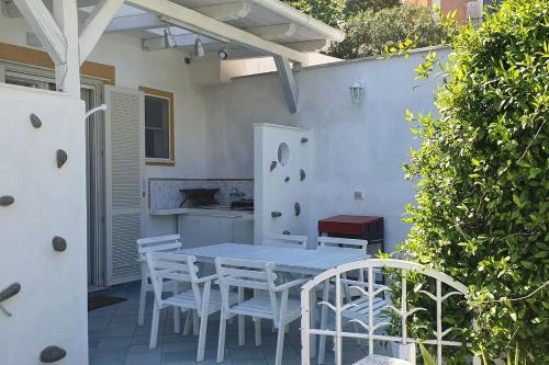 a white table and chairs on a patio at Marbnb Appartamenti Ponza centro, Porto Appartamento Ponza in Ponza