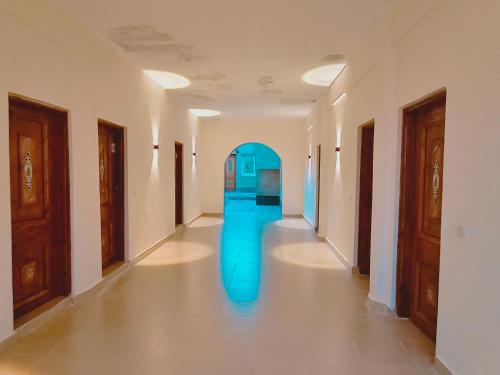 a hallway with a blue object in a room at Star Dune Camp in Nuweiba