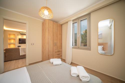 a bedroom with a bed and a mirror at Marigoulis Home in Sami