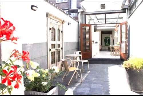 an outdoor patio with chairs and tables and flowers at Apartment close to campus in Nijmegen