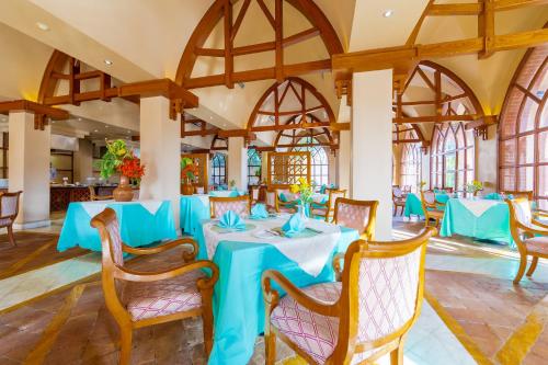 a dining room with blue tables and chairs at Makadi Palace - Couples and Families Only in Hurghada