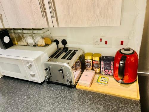 a kitchen counter with a toaster oven and other items at Very Lovely and Central 1-Bed Apartment in London in London