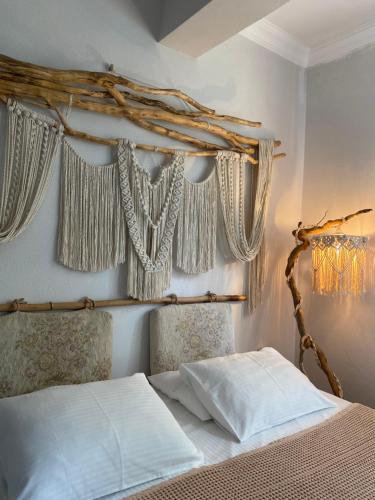 a bedroom with a bed with curtains on the wall at Vayu Hotel&Tiny Houses in Canakkale