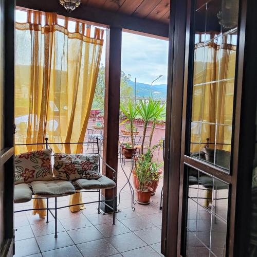 a living room with a couch on a balcony at B&B Home Holiday Villa delle Acacie agriturismo in Sala Consilina