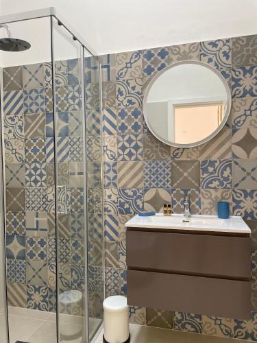 a bathroom with a sink and a mirror at A'mmare Rooms&Apartments Santa Maria di Leuca in Leuca