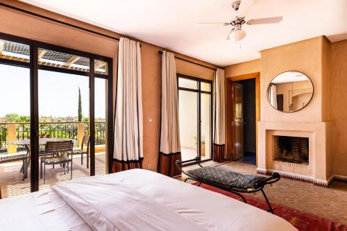 a bedroom with a bed and a fireplace at Villa de Luxe avec Piscine Privée et Golf in Marrakesh